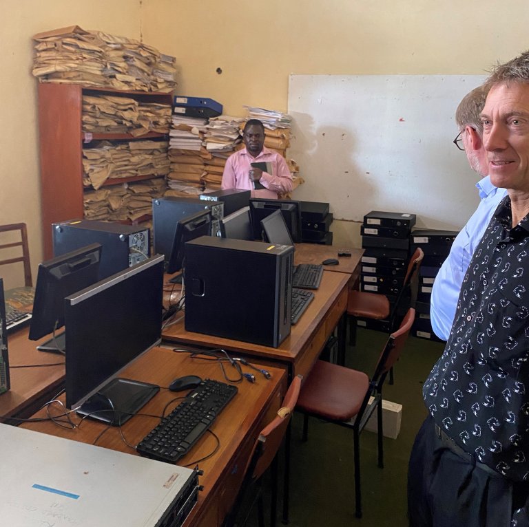 A photo showing three people assessing the equipment in the data processing room in the NSO of Malawi.